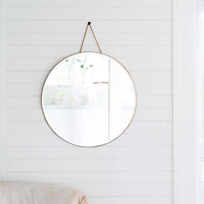 Brass porthole mirror on white wall from Monsoon Living Newcastle